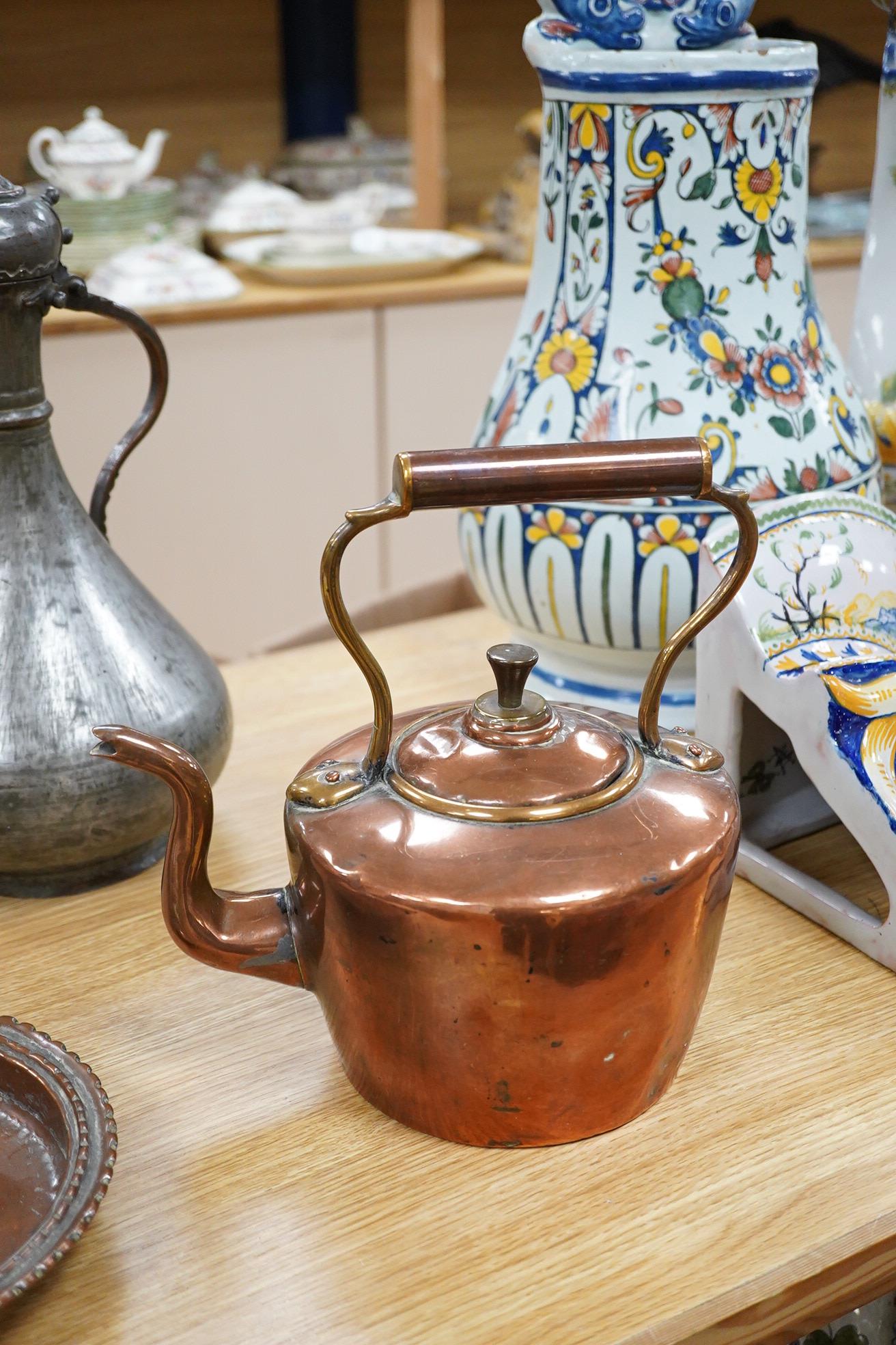 Two Middle eastern tinned copper coffee pots ‘Dallah’ a similar dish and a European copper kettle, tallest 41cm high